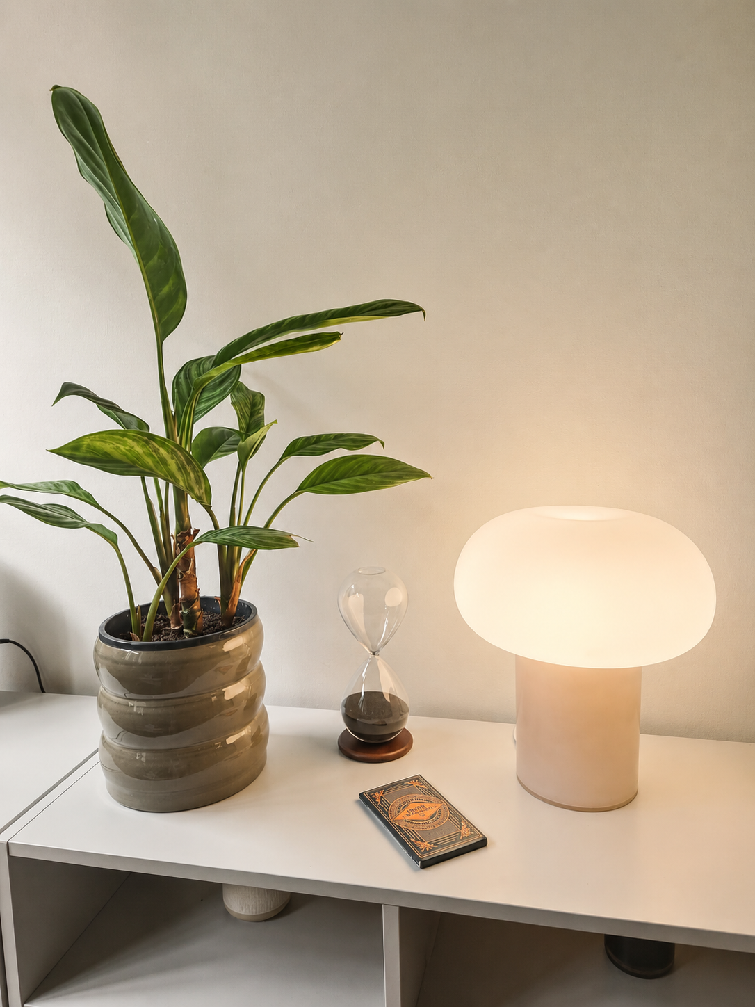 A warm lamp, hourglass and plant in the Bethnal Green therapy room